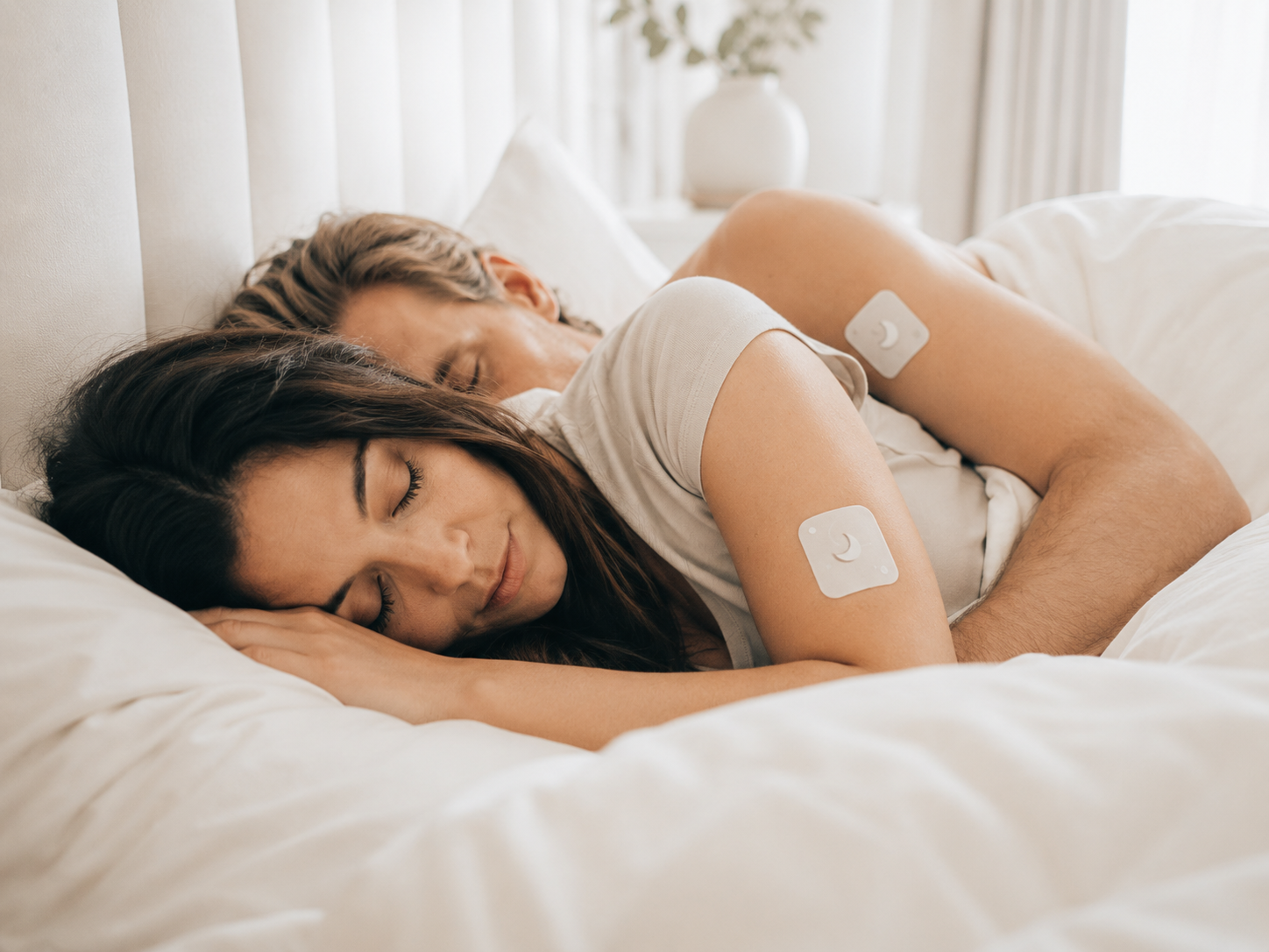 Couple sleeping peacefully with LULLS patch on arm